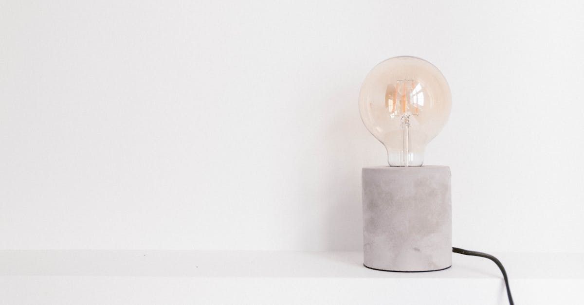 A light bulb is sitting on top of a concrete block on a table.