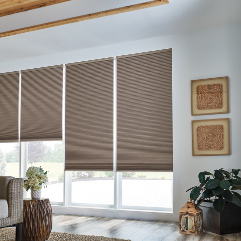 Room with taupe cellular shades, neutral walls, natural wood elements.