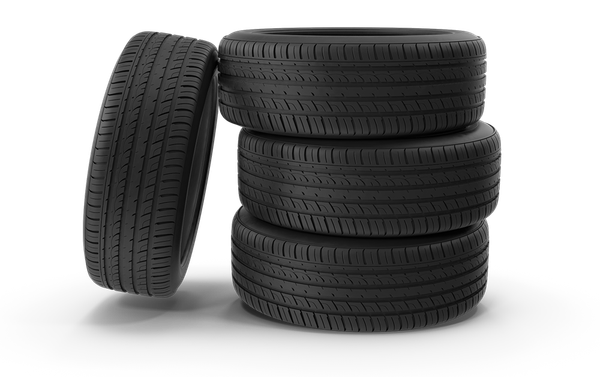 Four tires are stacked on top of each other on a white background.