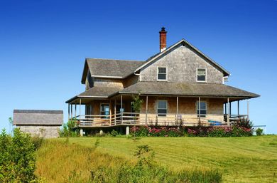 a large house sitting on top of a lush green field