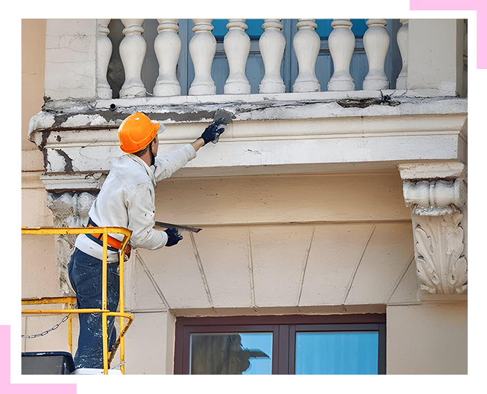 A man is painting a balcony on a building.