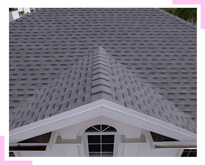 A house with a gray roof and a white trim.