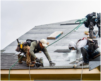 A group of men are working on a roof.