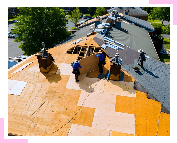 A group of men are working on a roof.