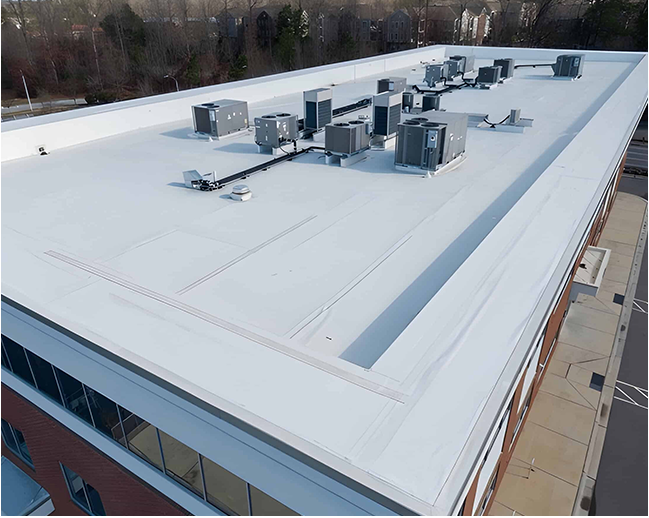 An aerial view of a large white roof of a building.