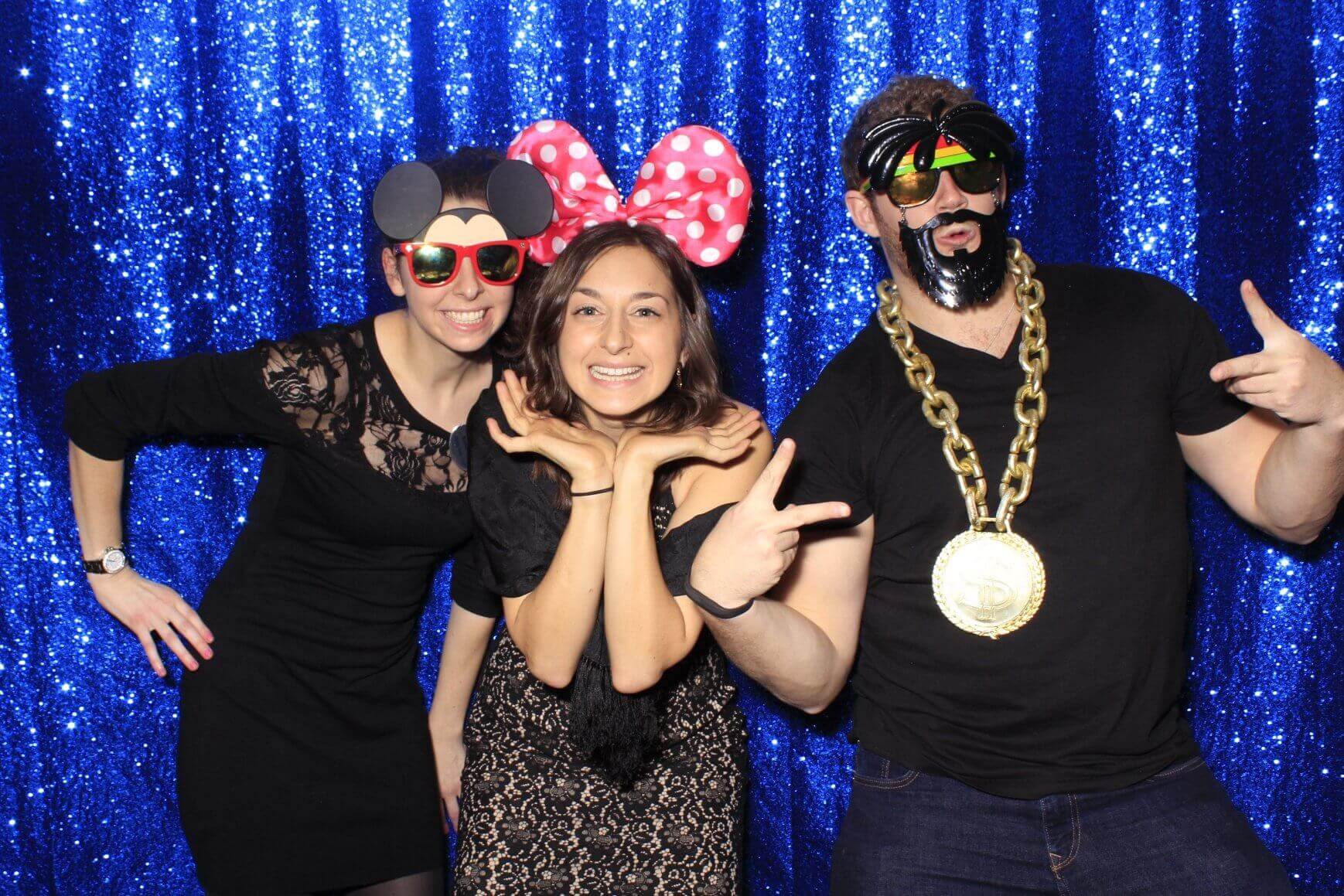 Photo booth rental in Toronto for an event. Posing in front of a blue sequin glitter backdrop offered by LOL Photo Booth. Tags: Event planning ideas, Photo booth prints, high resolution photos, Toronto photo booth rental services. GIFS, Boomerangs, Mosaic Walls, Slow motion, brand activation.