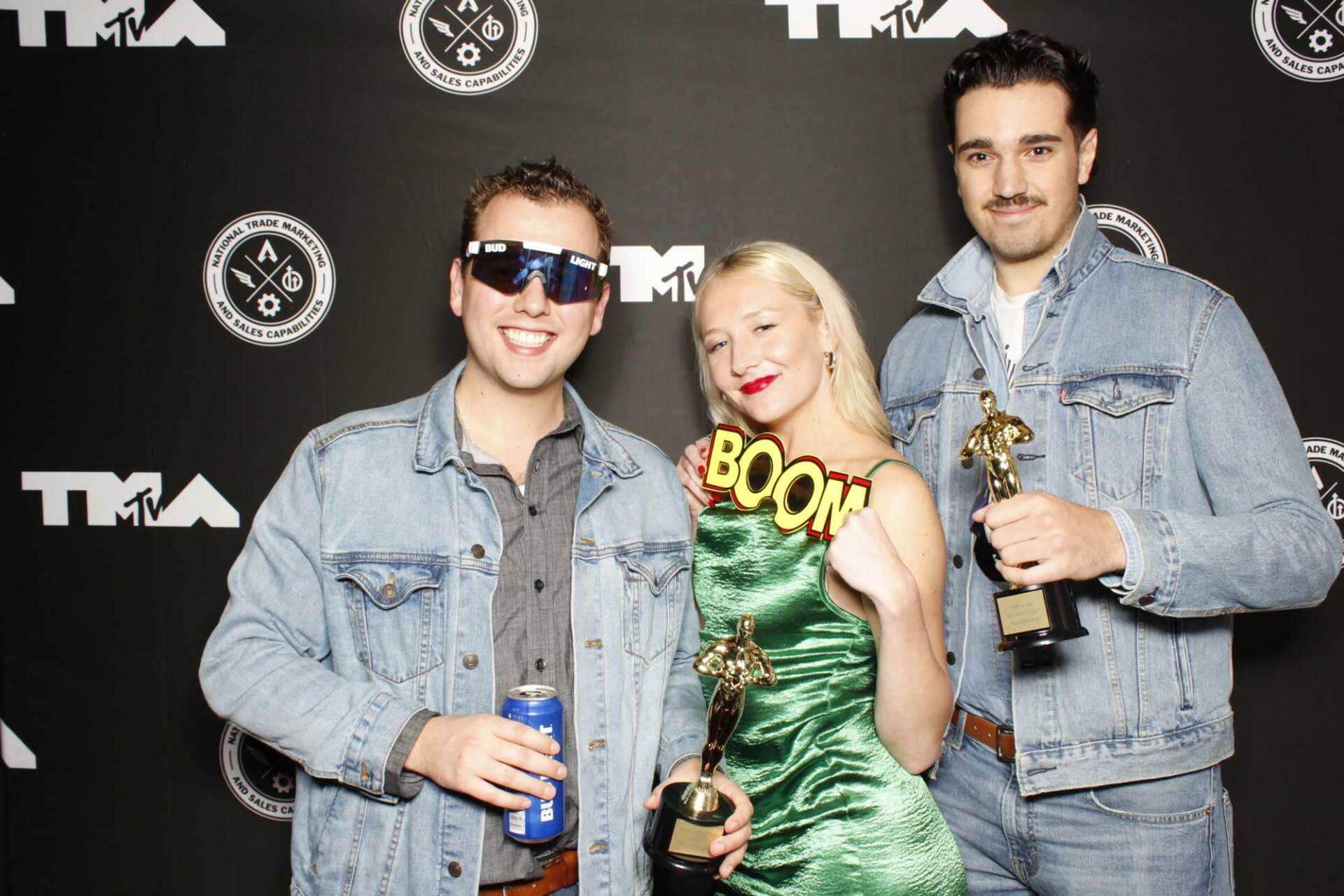 A group of people standing next to each other holding trophies.