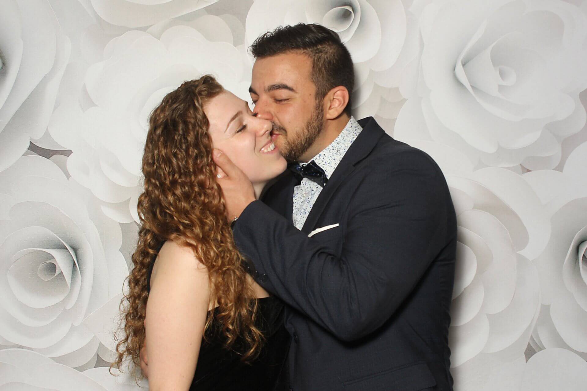 Photo booth rental in Toronto for an event. Posing in front of a 3D white flower wall backdrop offered by LOL Photo Booth. Tags: Event planning ideas, Photo booth prints, high resolution photos, Toronto photo booth rental services. GIFS, Boomerangs, Mosaic Walls, Slow motion, brand activation.