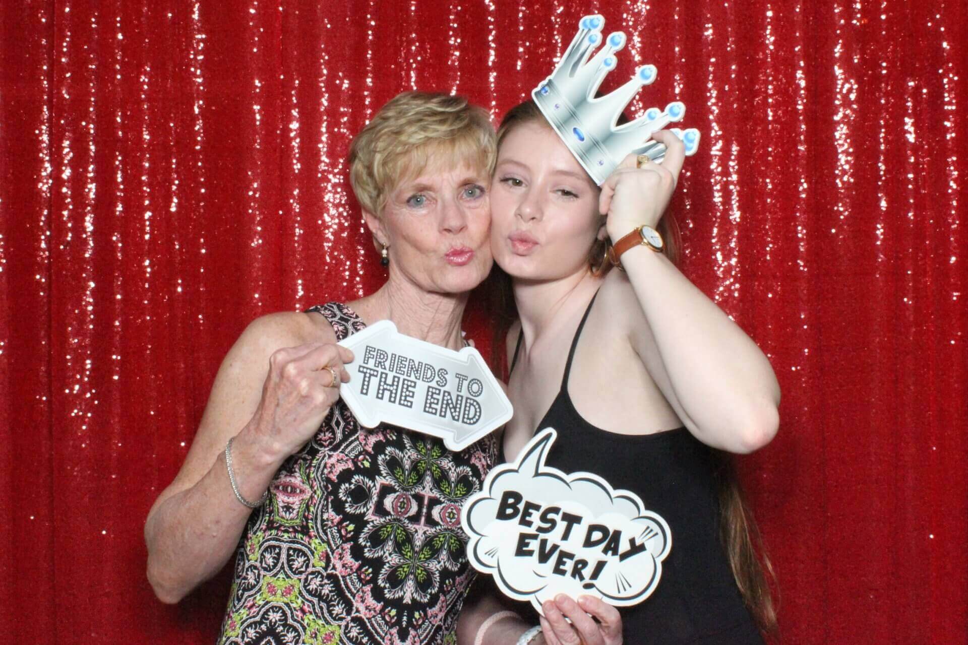 Photo booth rental in Toronto for an event. Posing in front of a red sequin backdrop offered by LOL Photo Booth. Tags: Event planning ideas, Photo booth prints, high resolution photos, Toronto photo booth rental services. GIFS, Boomerangs, Mosaic Walls, Slow motion, brand activation.