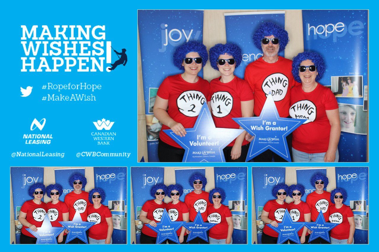 A group of people wearing red shirts and blue wigs are posing for a picture.