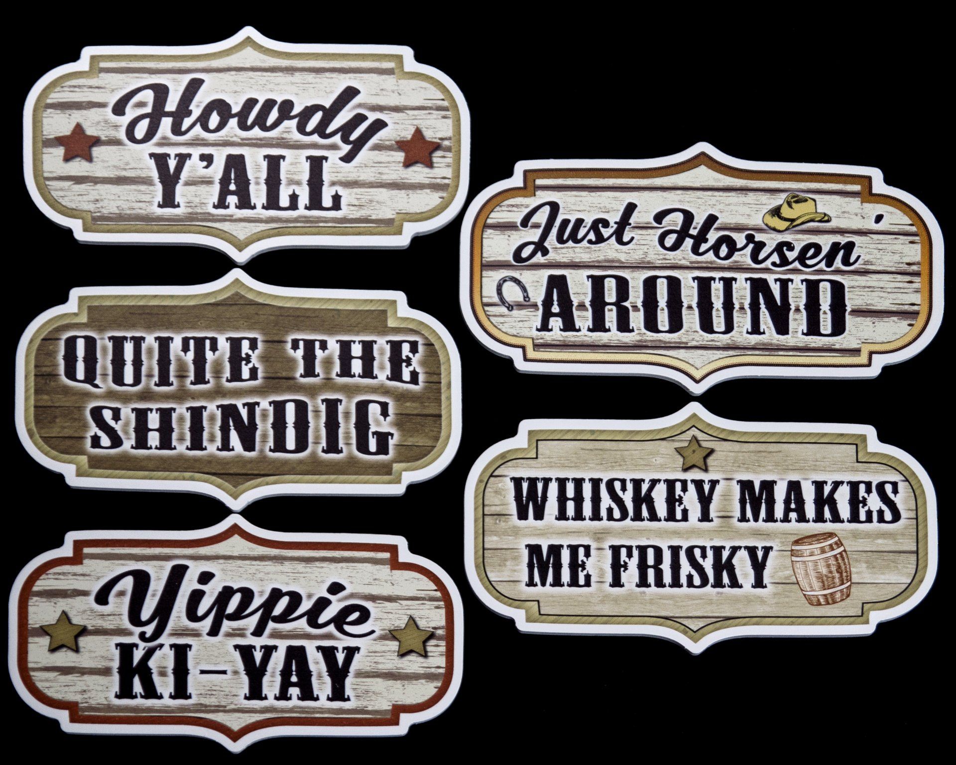 A set of four wooden signs with cowboy sayings on them.