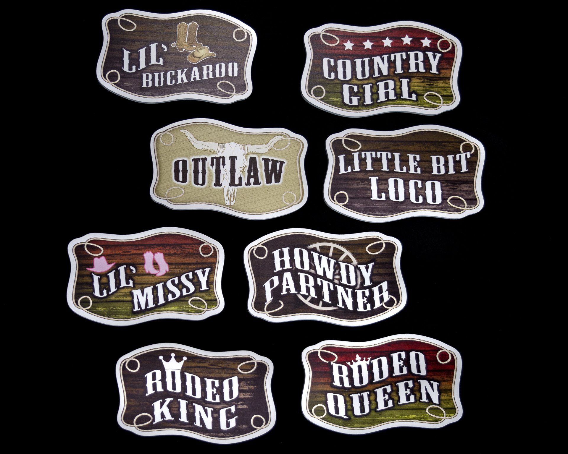 A bunch of stickers with cowboy sayings on them