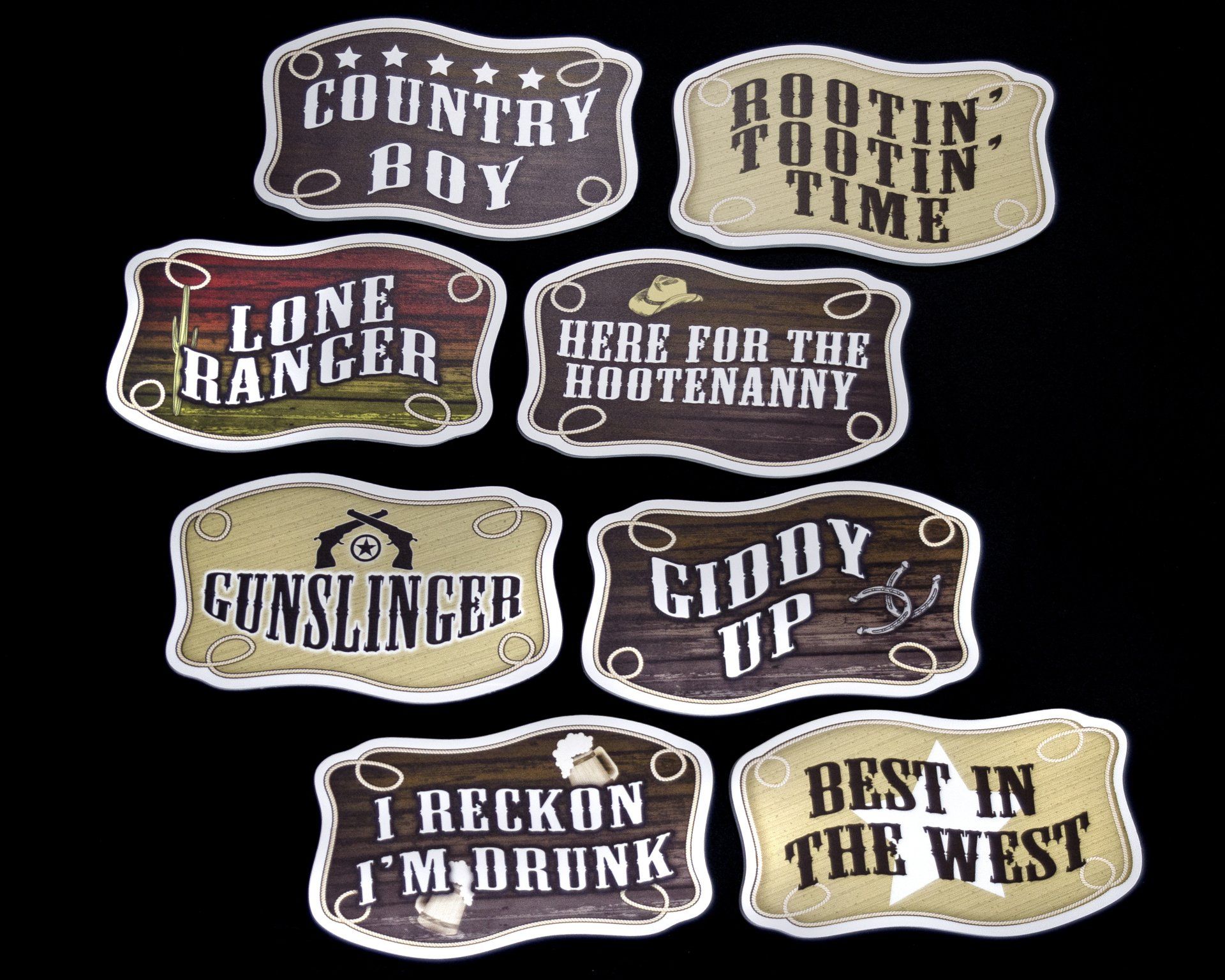 A bunch of stickers with cowboy sayings on them