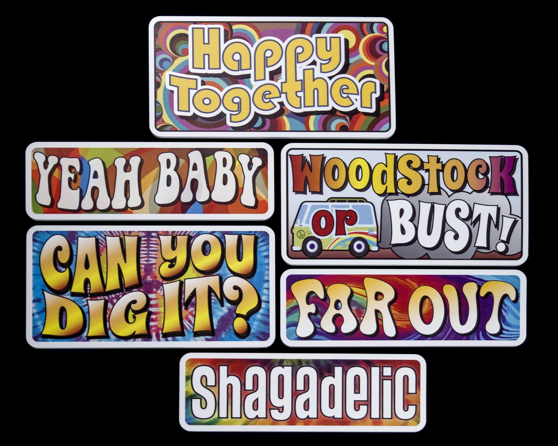 A bunch of stickers that say happy together yeah baby woodstock or bust can you dig it far out and shagadelic