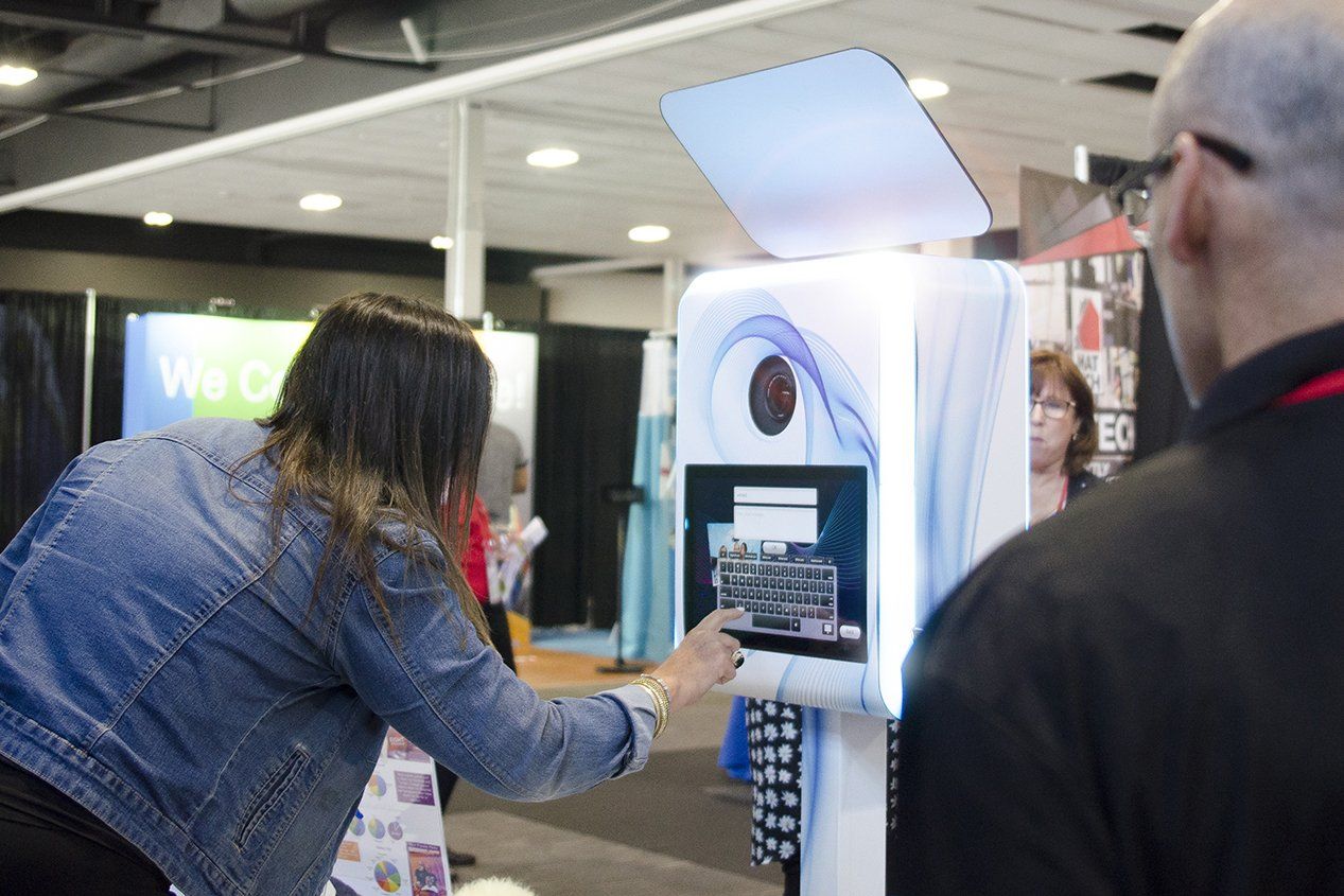 A woman is taking a picture of herself in a photo booth.