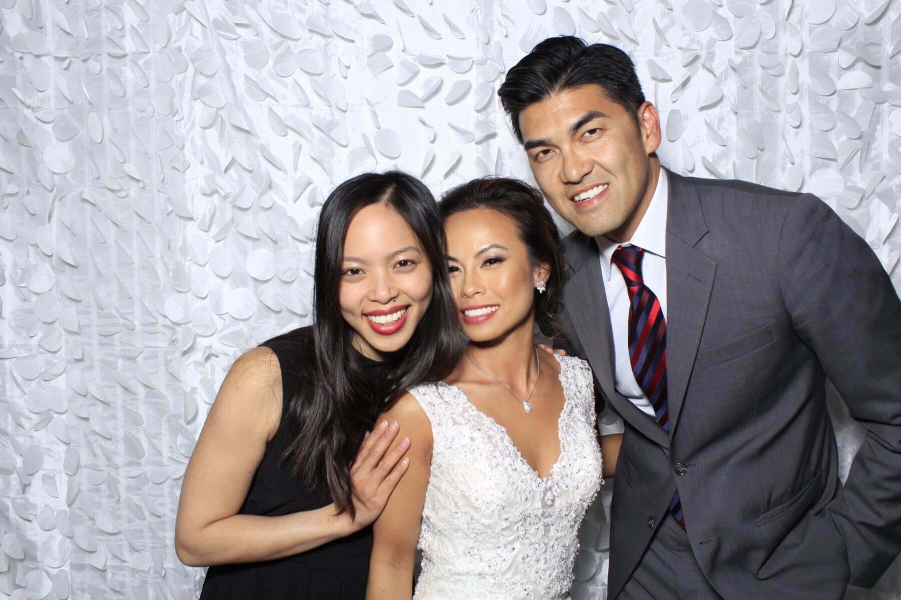 Photo booth rental in Toronto for an event. Posing in front of a beautiful white petal backdrop offered by LOL Photo Booth. Tags: Event planning ideas, Photo booth prints, high resolution photos, Toronto photo booth rental services. GIFS, Boomerangs, Mosaic Walls, Slow motion, brand activation.