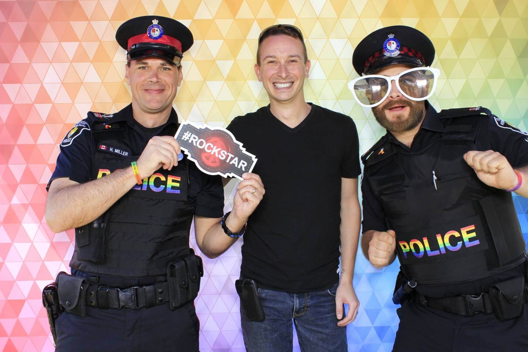 Photo booth rental in Toronto for an event. Posing in front of a fun mosaic backdrop offered by LOL Photo Booth. Tags: Event planning ideas, Photo booth prints, high resolution photos, Toronto photo booth rental services. GIFS, Boomerangs, Mosaic Walls, Slow motion, brand activation.