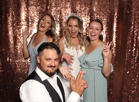 A group of people are posing for a picture in a photo booth.
