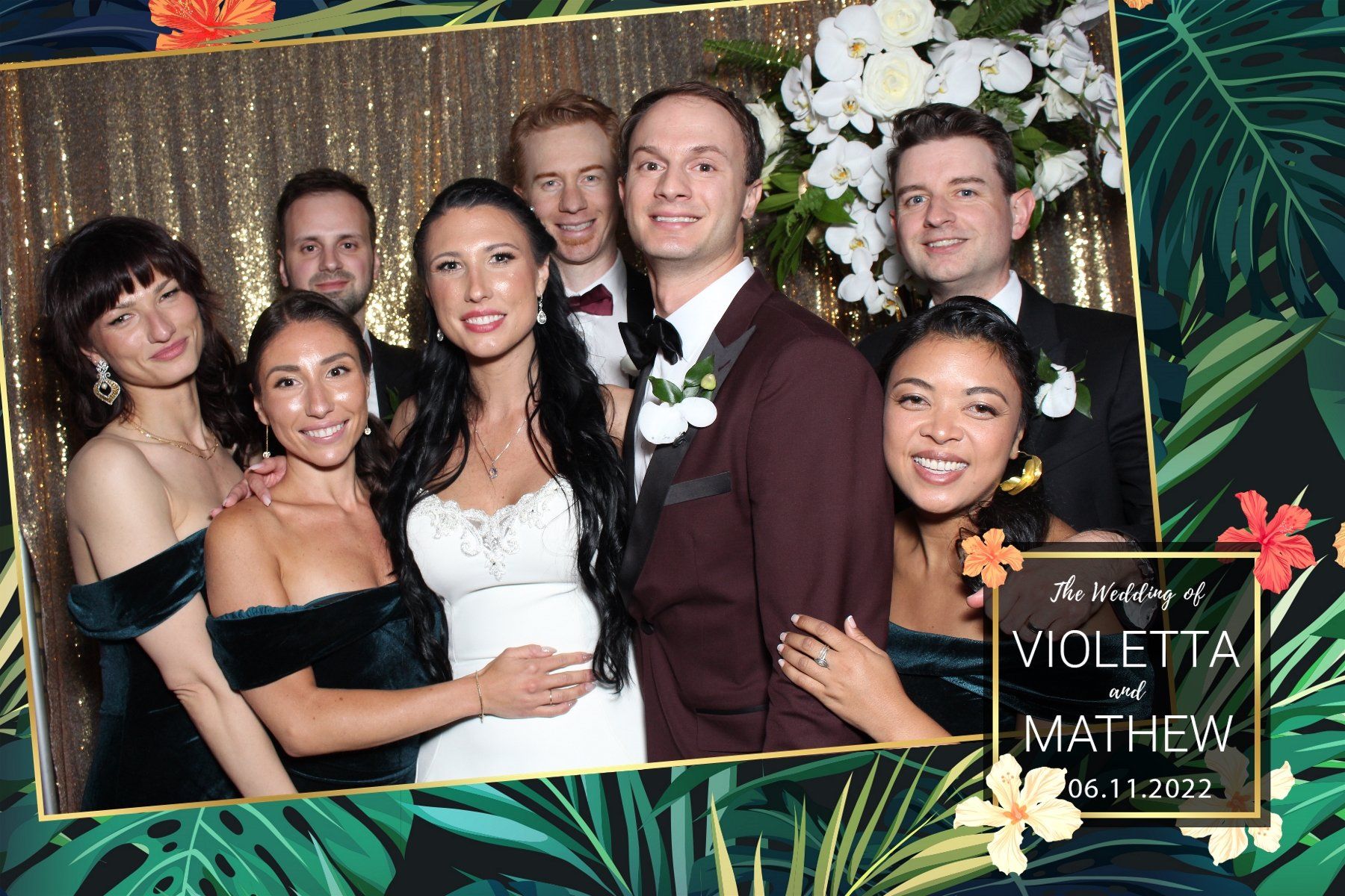 A bride and groom are posing for a picture with their wedding party.