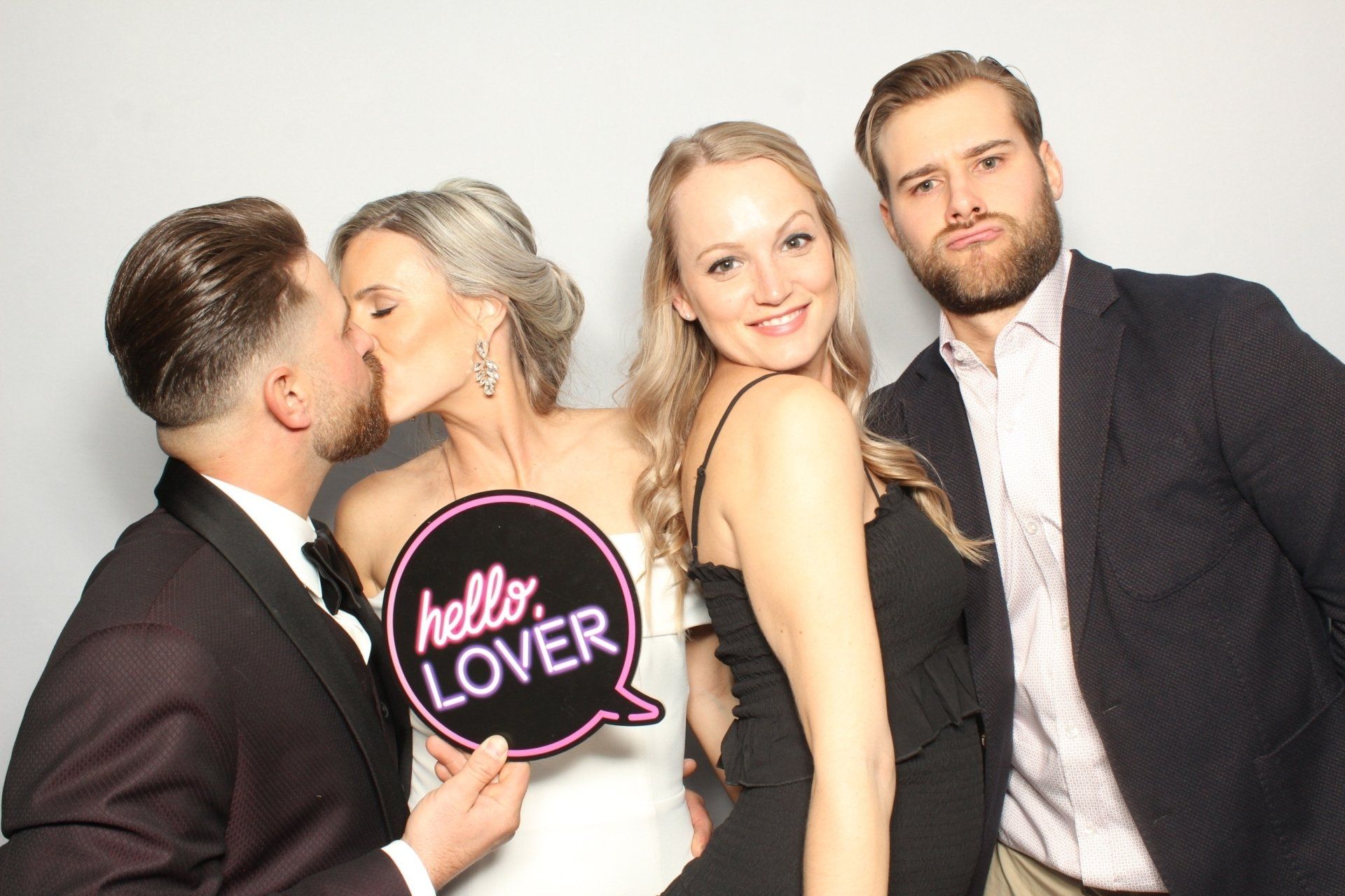 A group of people are posing for a picture in a photo booth.