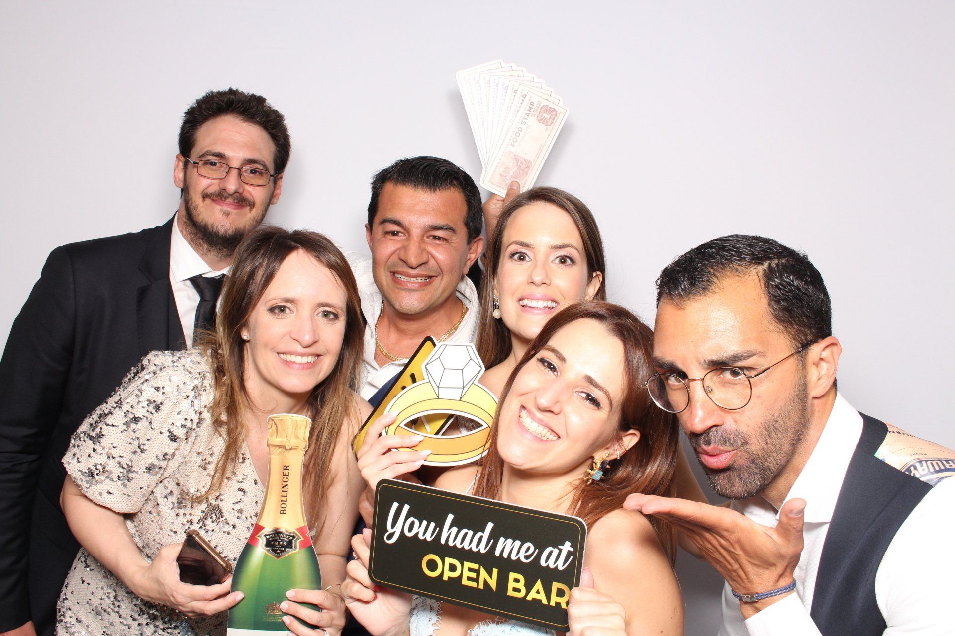 A group of people are posing for a picture in a photo booth.