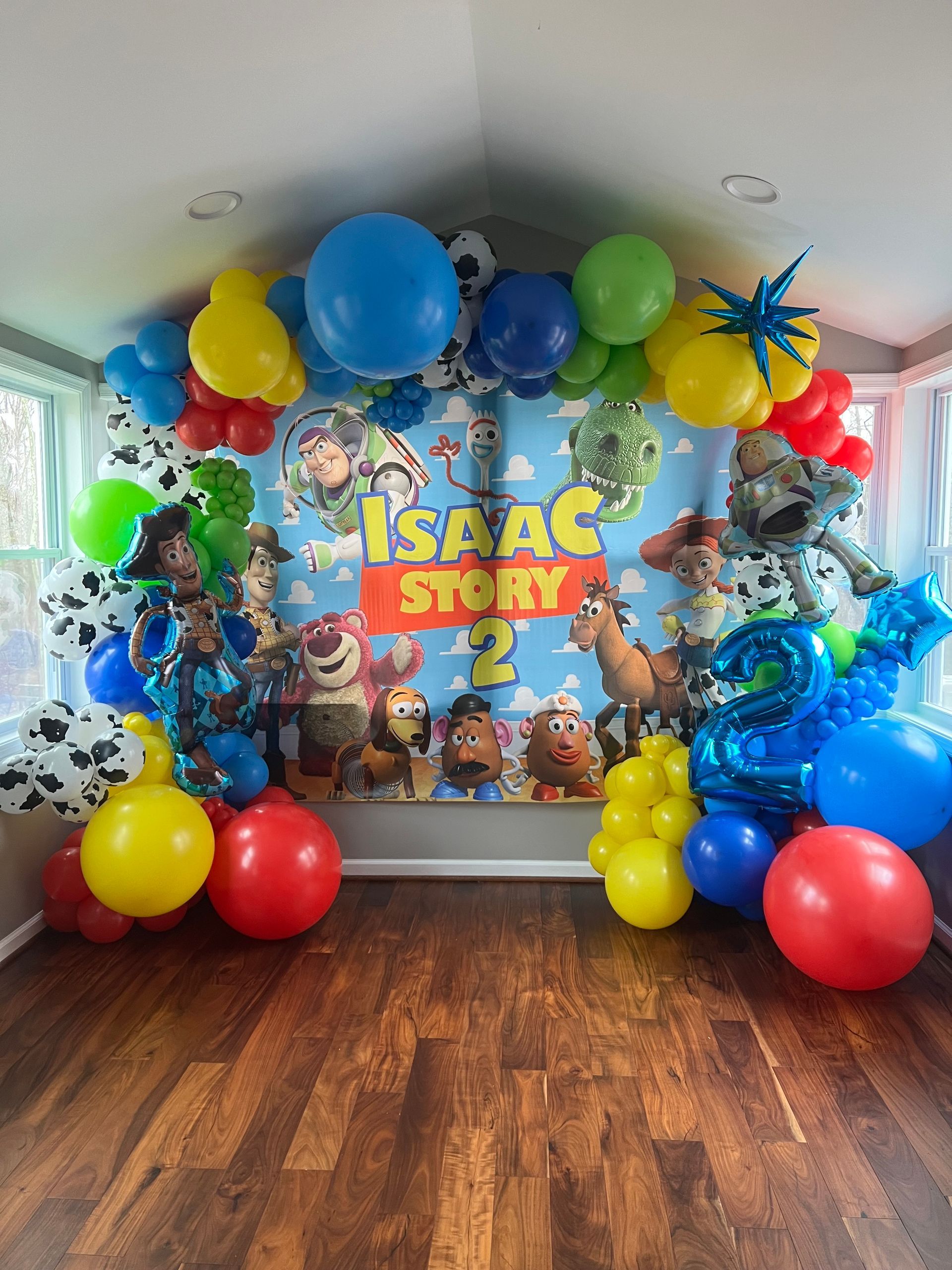A room decorated with balloons for a toy story birthday party.