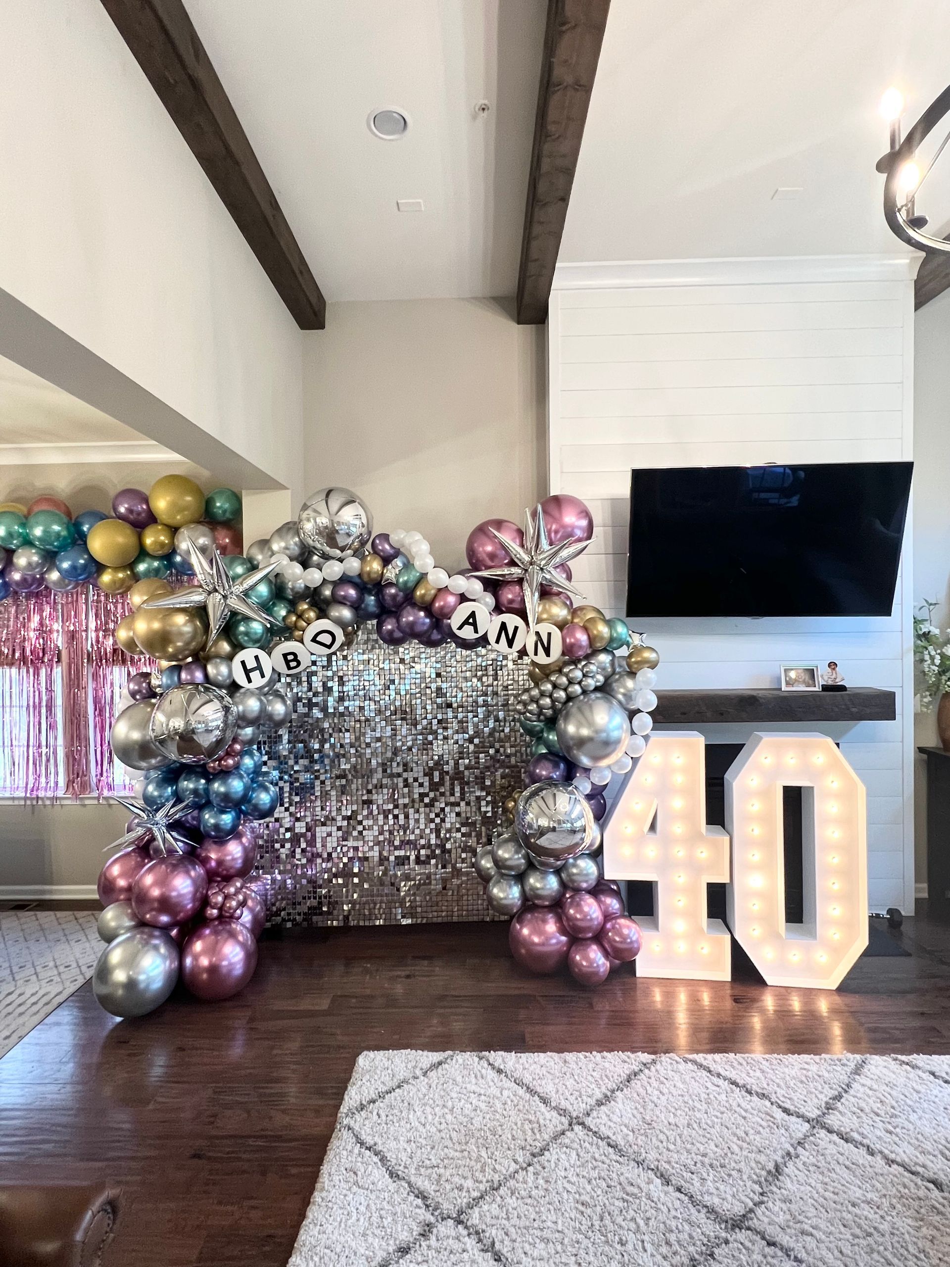 A living room filled with balloons and a 40 sign.