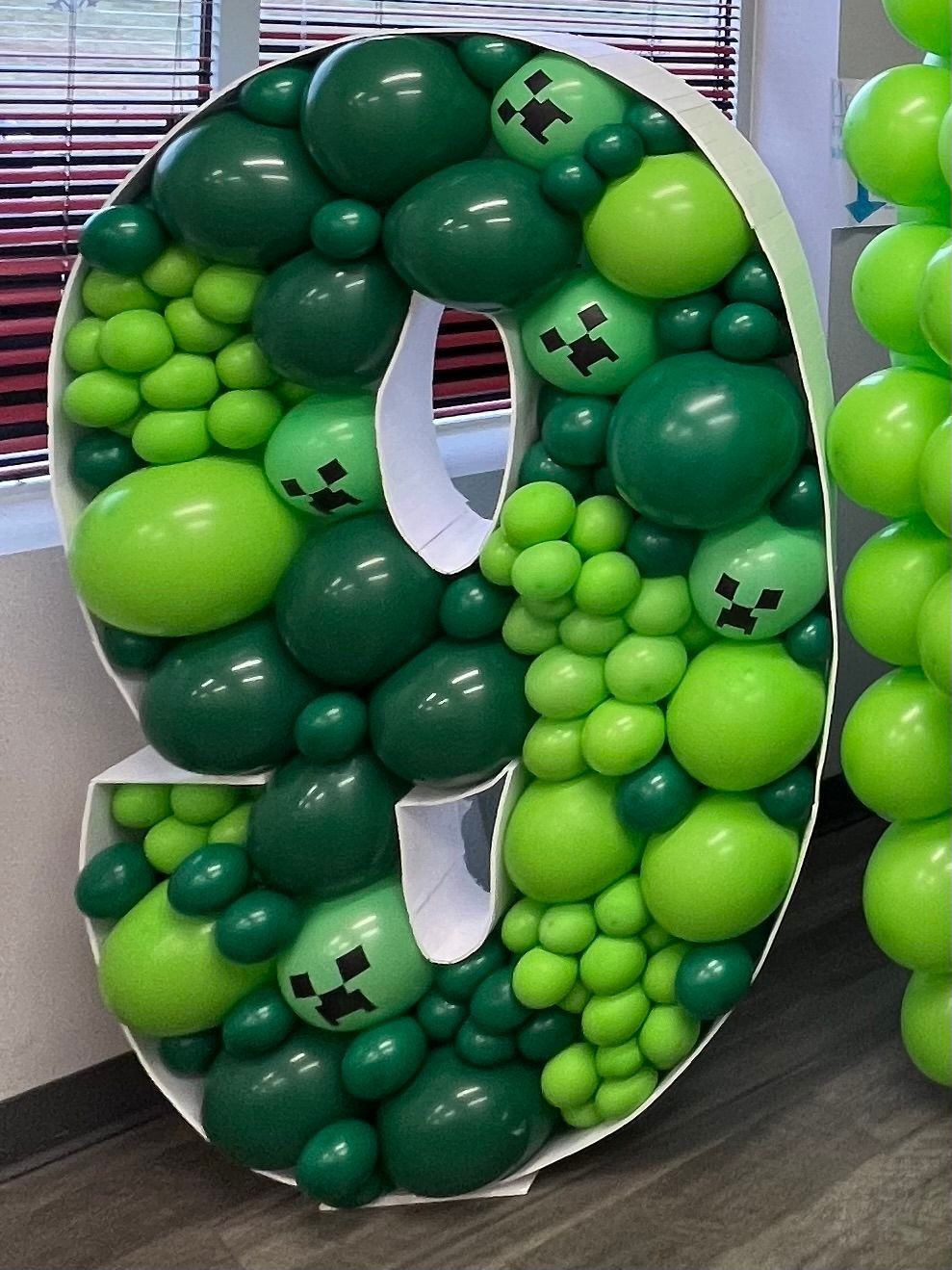 A large number 9 made out of green balloons