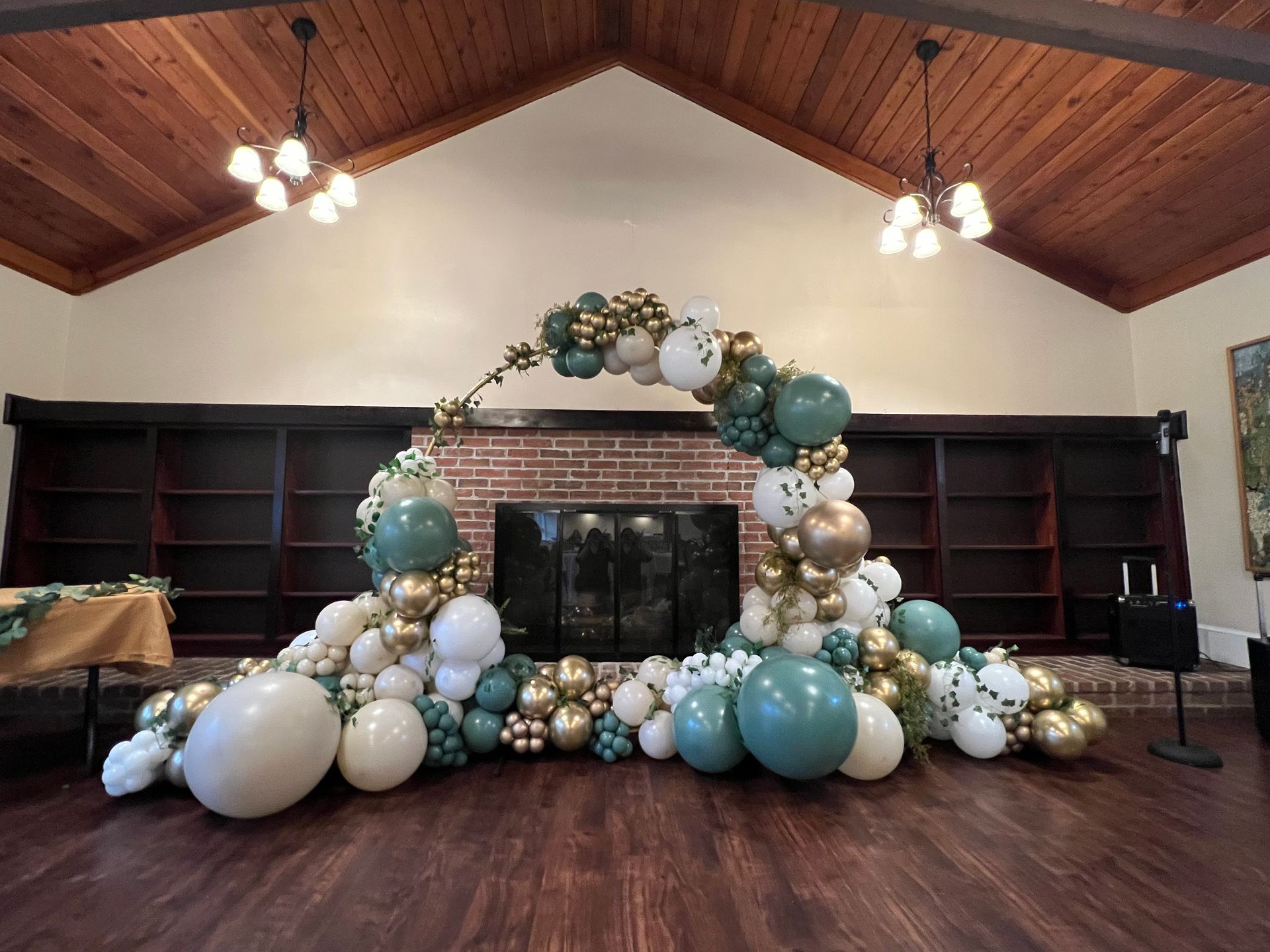 A room filled with balloons and a fireplace.
