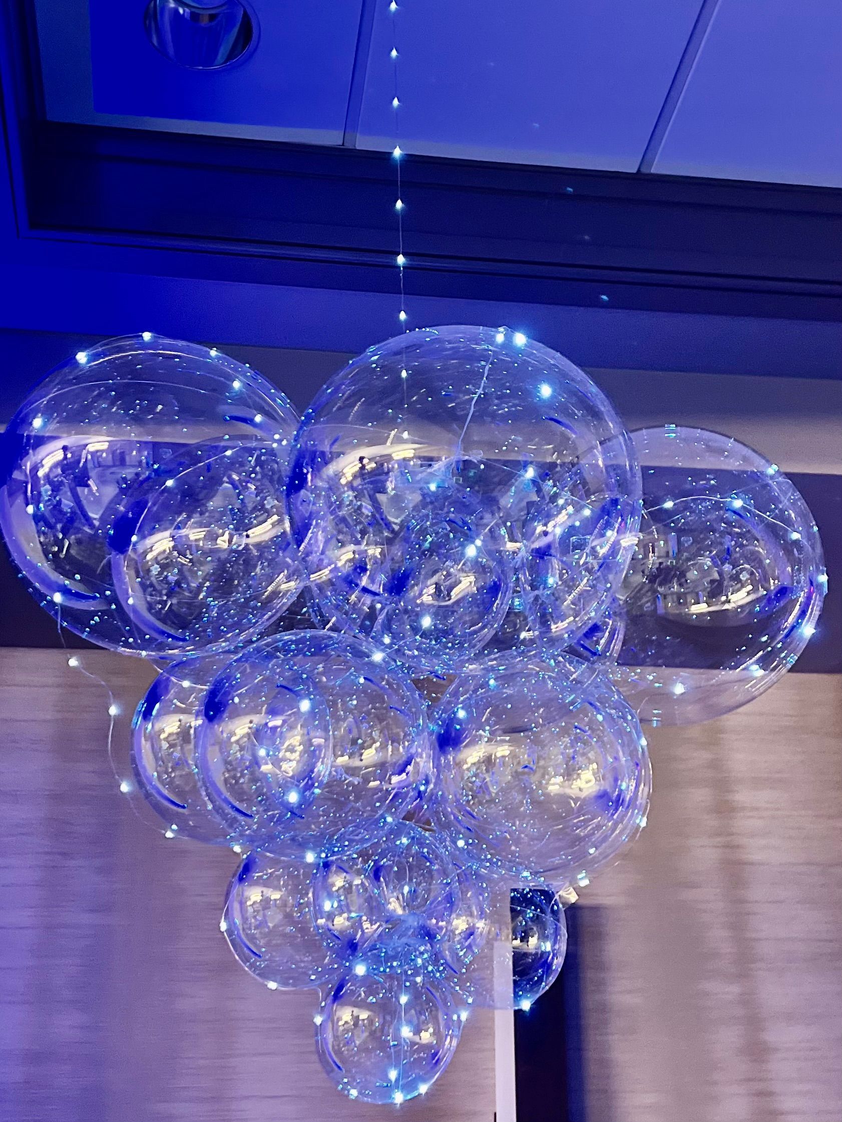 A bunch of clear balloons sitting on top of a table.