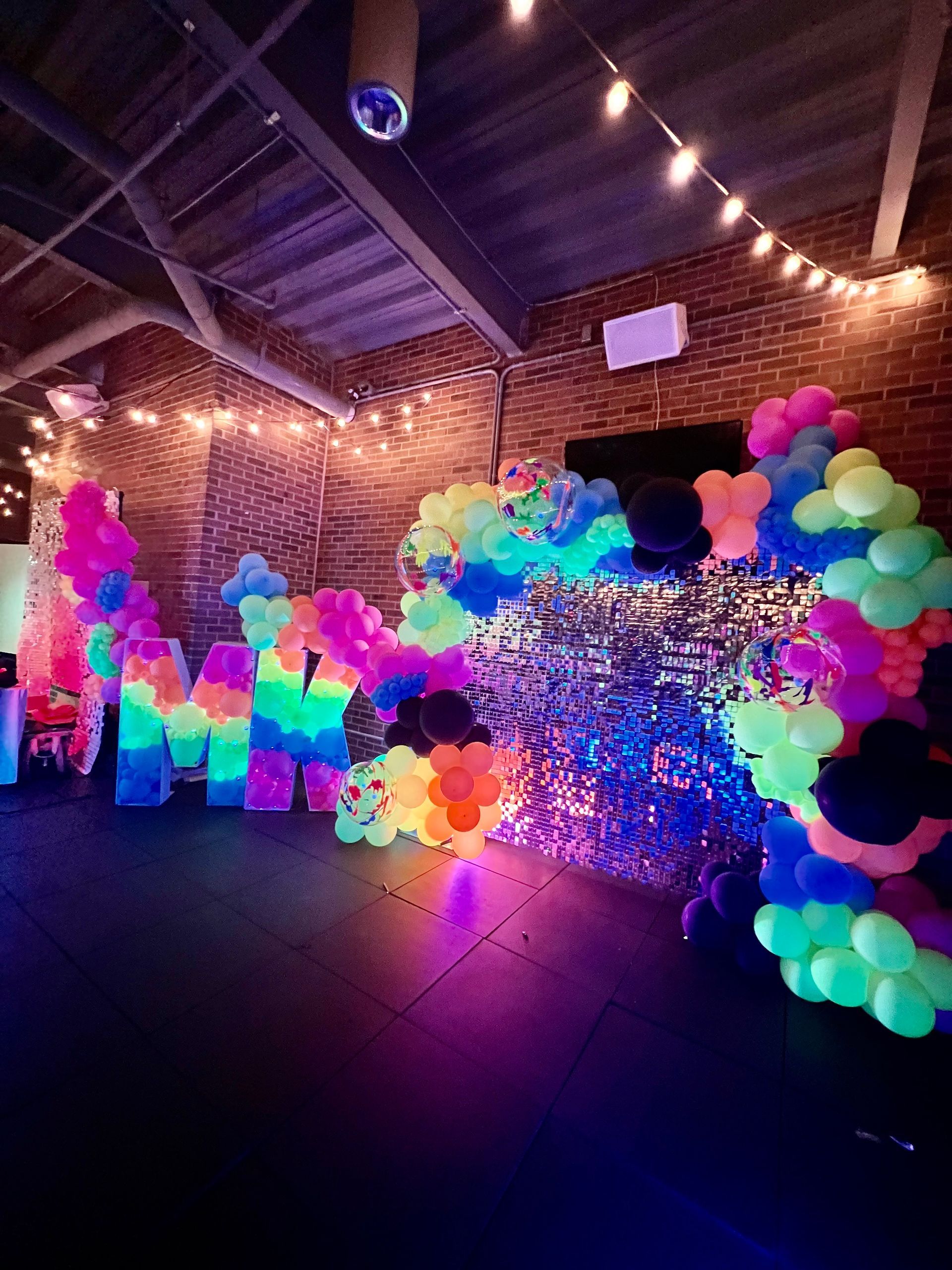 A room filled with lots of colorful balloons and lights.