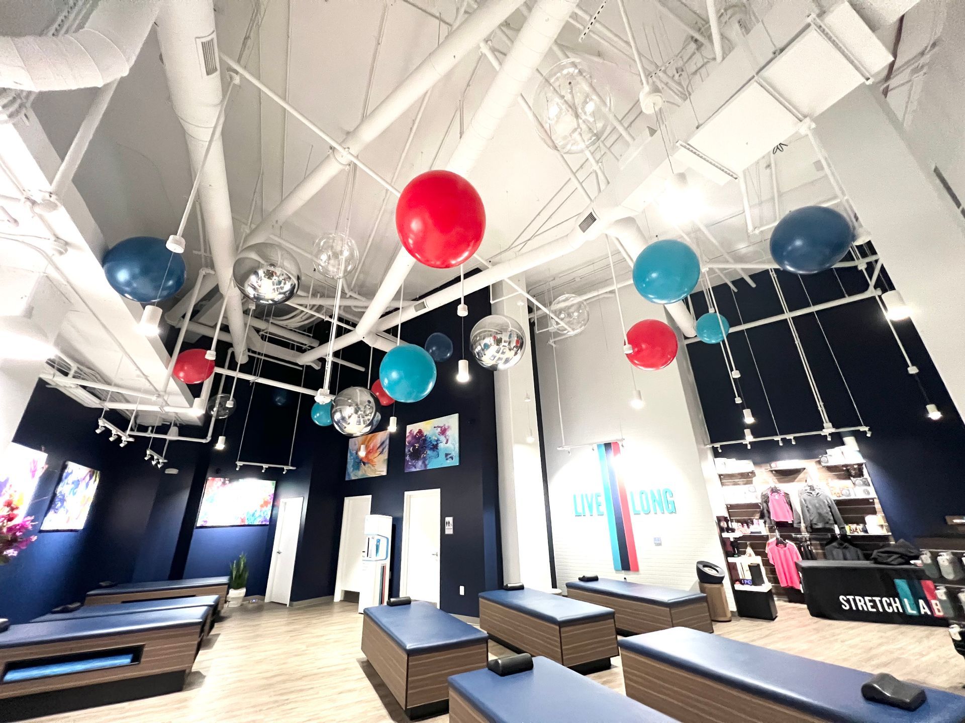 A room with a lot of balloons hanging from the ceiling