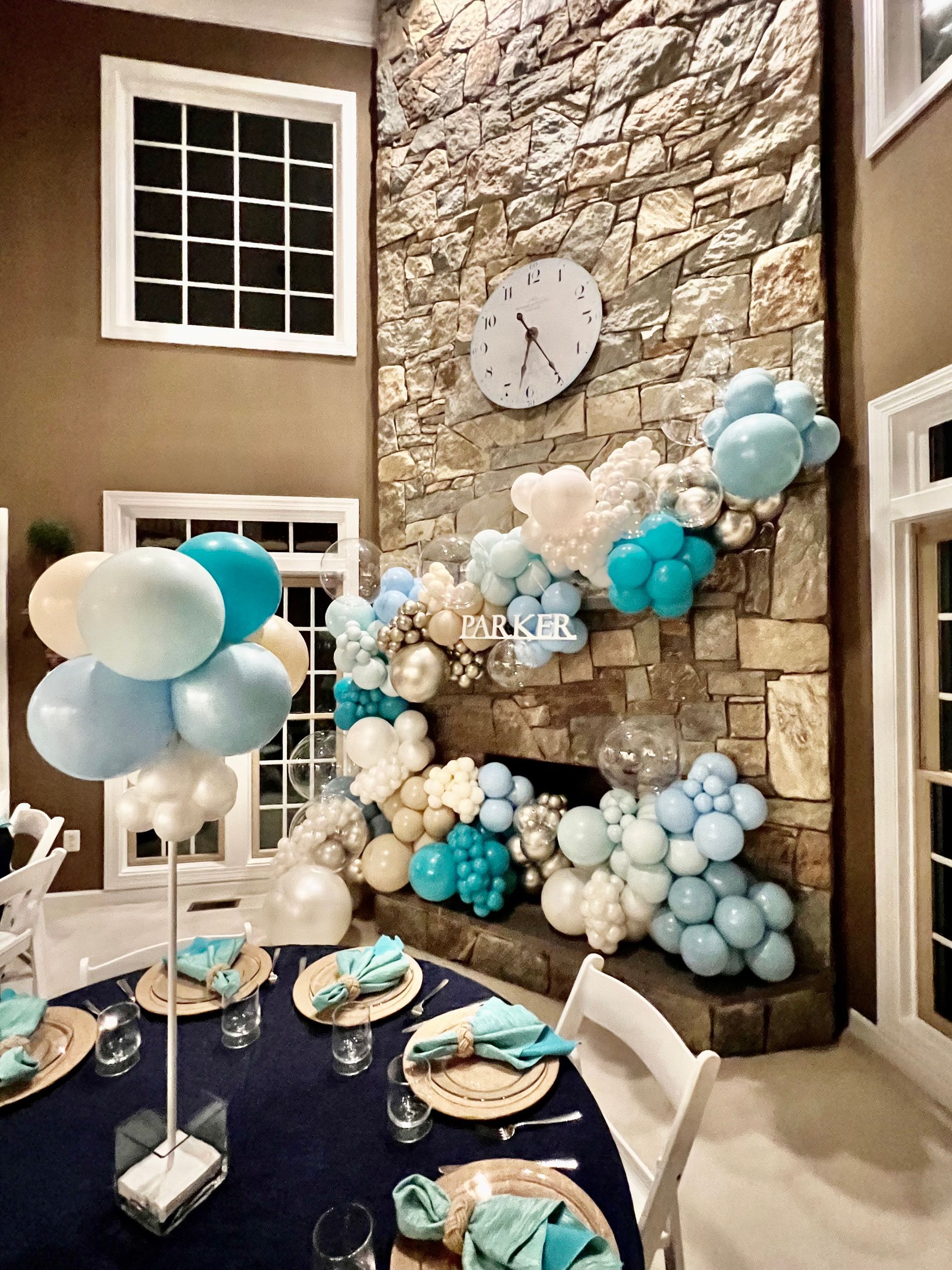 A room with a table and chairs and balloons on the wall.