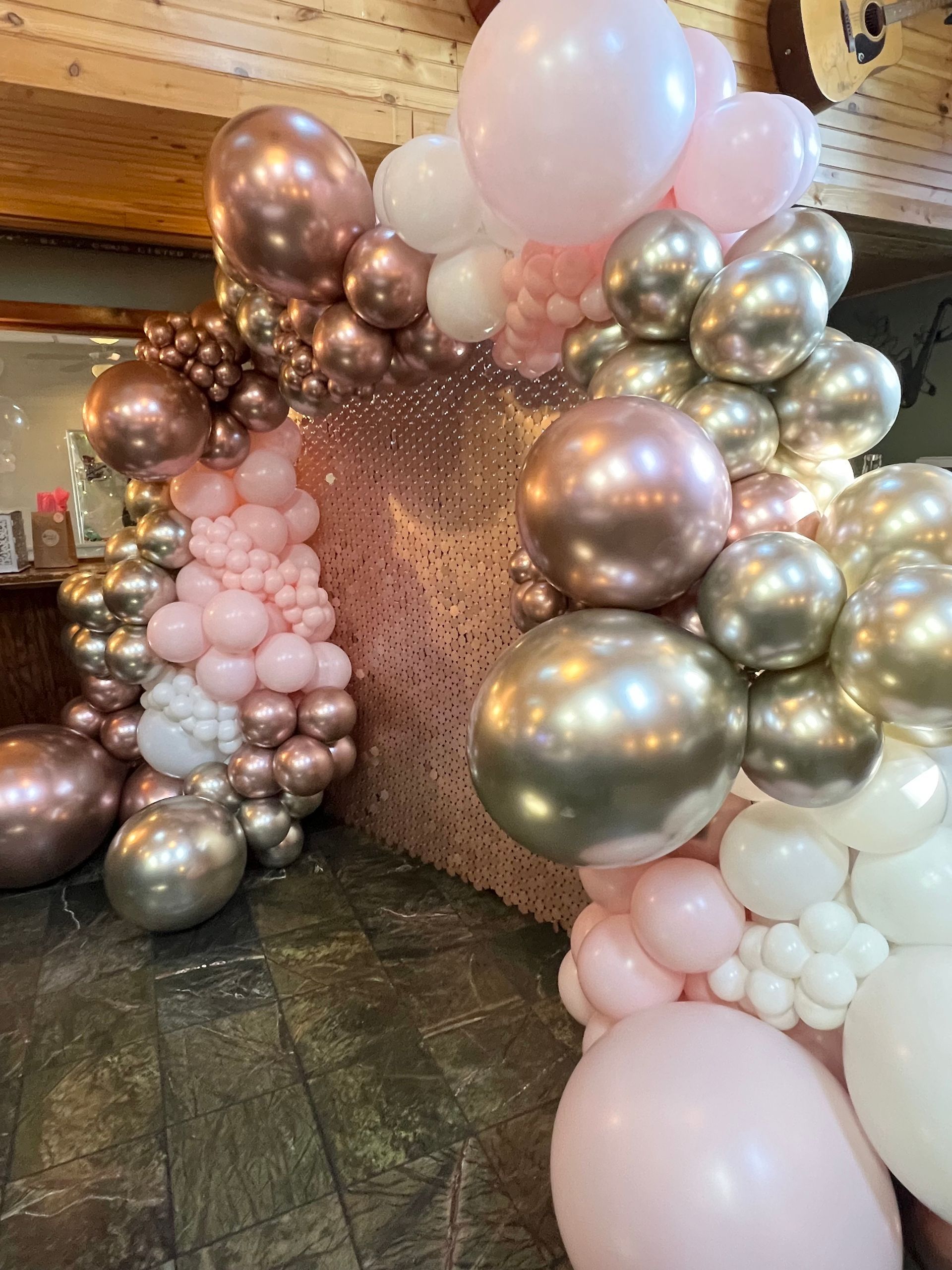 A bunch of balloons are sitting on the floor in a room.