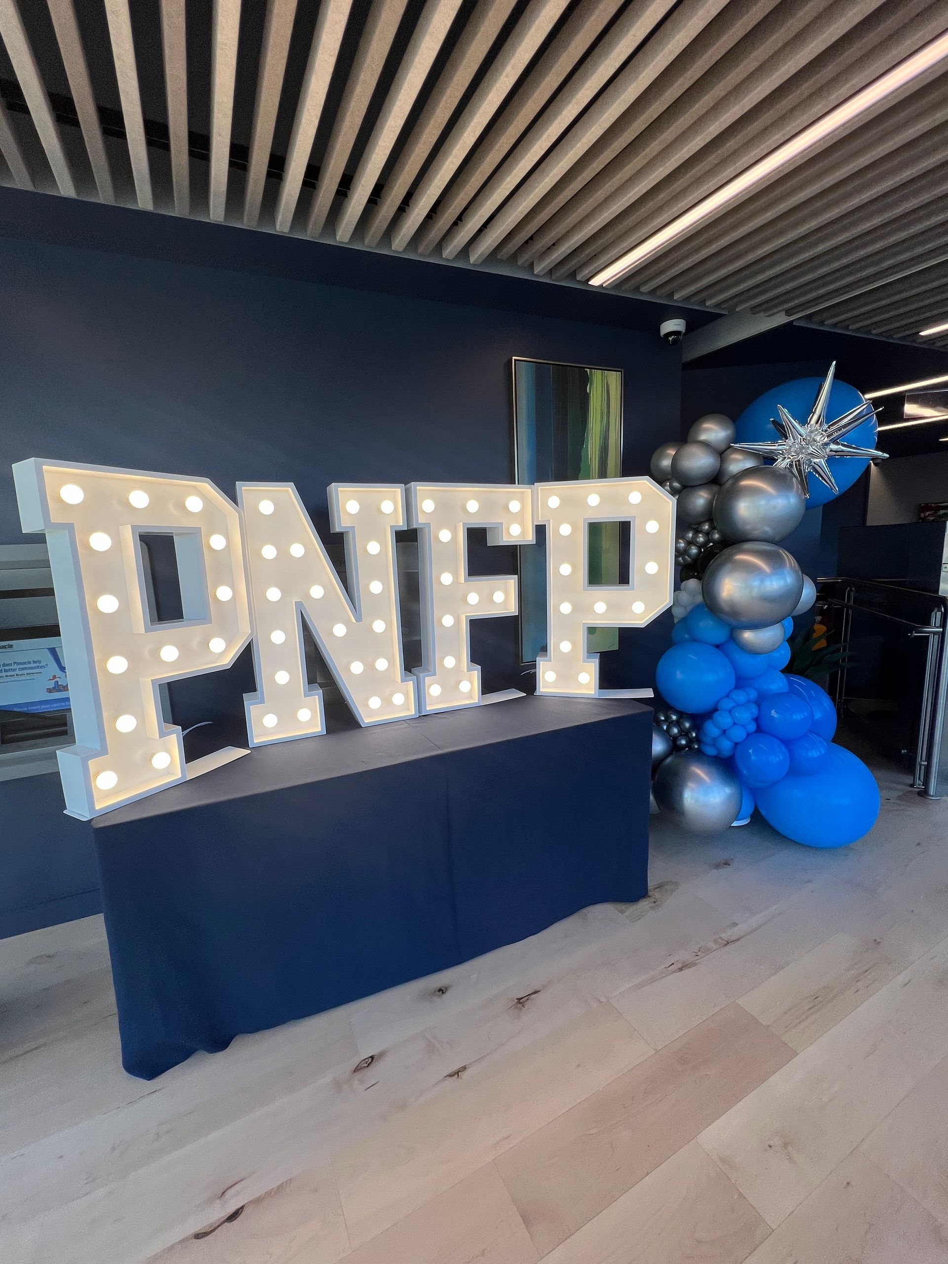 A large sign that says pnfp is sitting on top of a table.