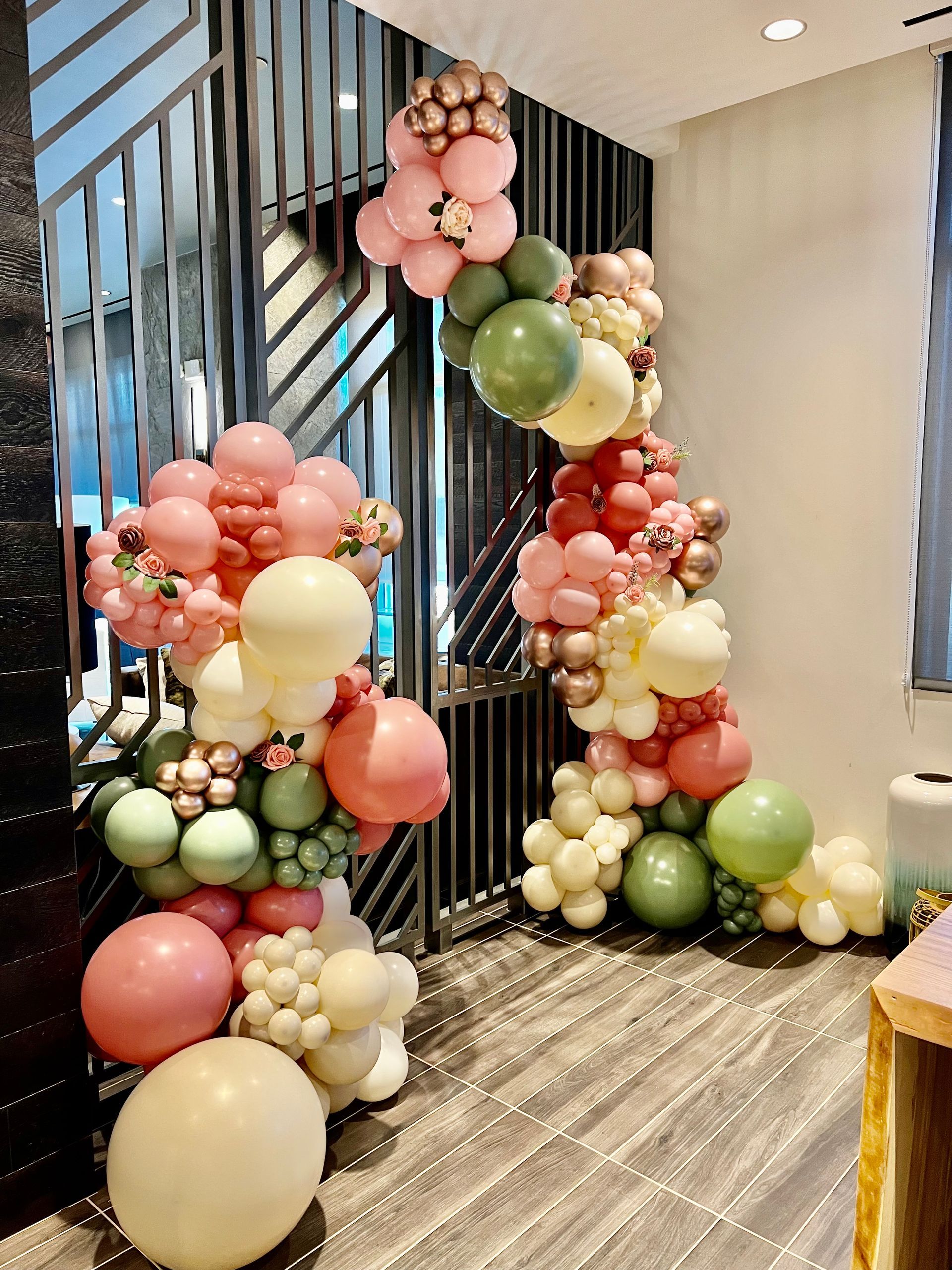 A bunch of balloons are sitting on the floor in a room.