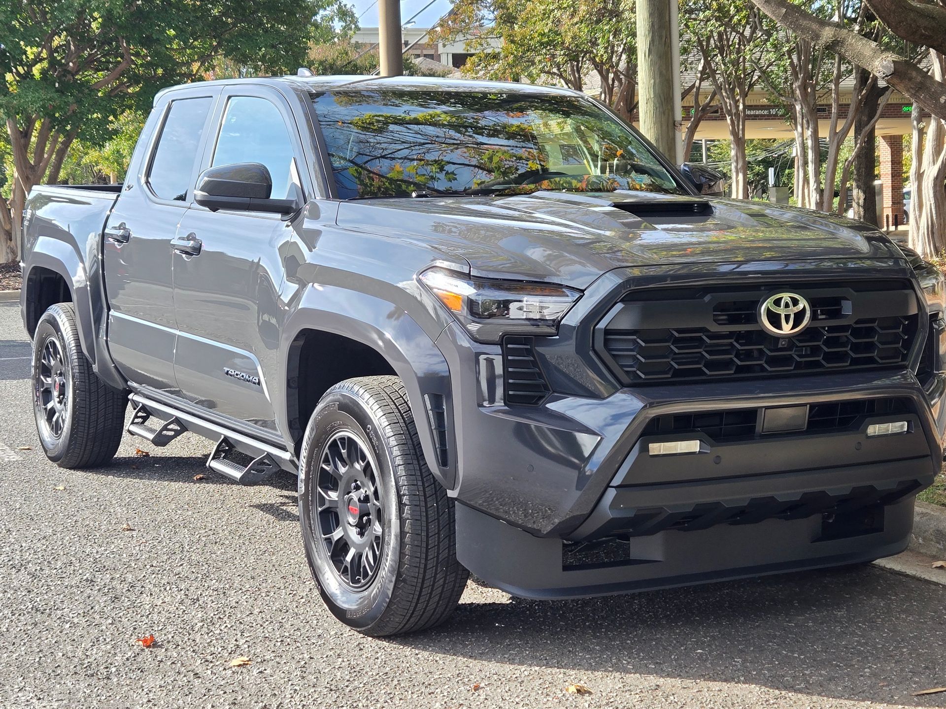 Gray Toyota Tacoma pickup truck parked on a paved road.