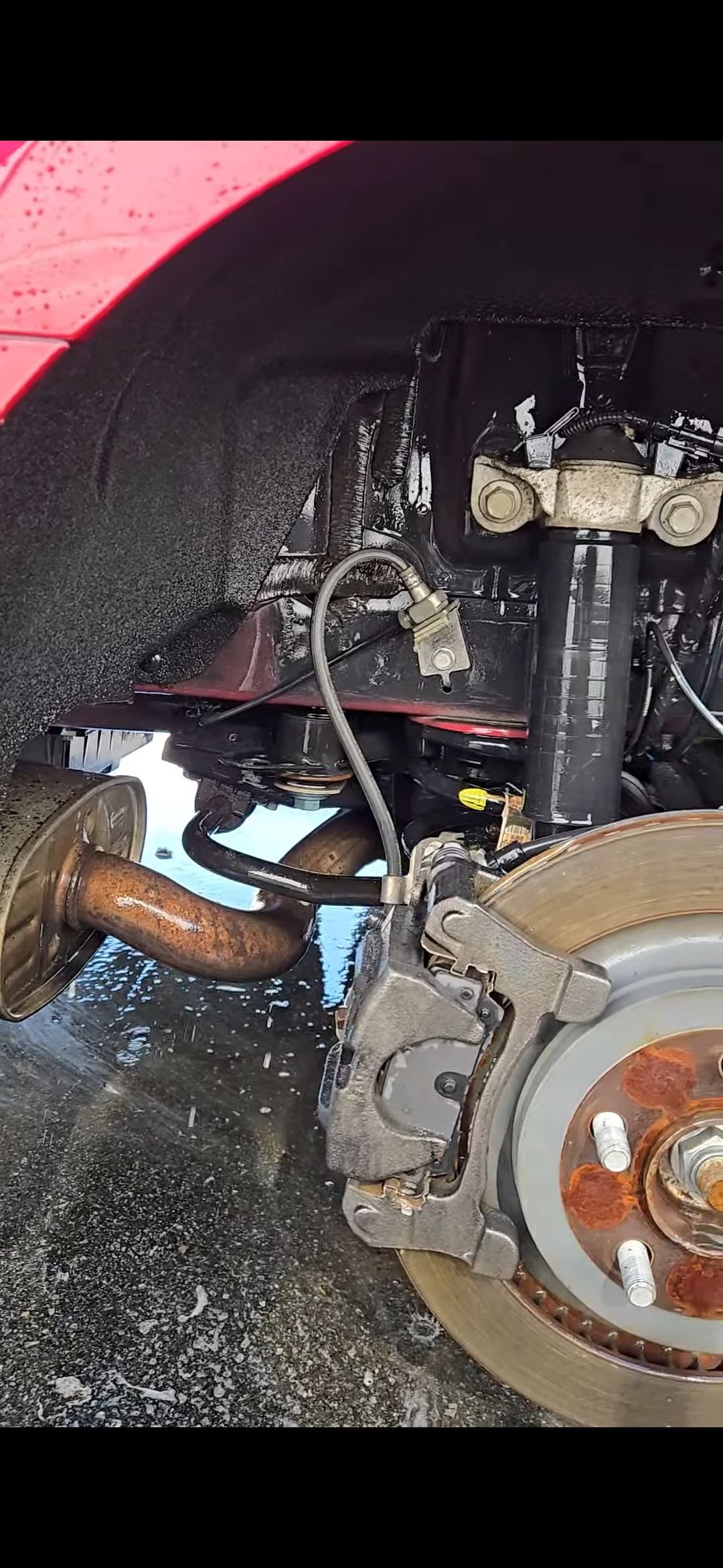 Audi SQ5 SUV engine bay with hood open; silver, black, and red components.