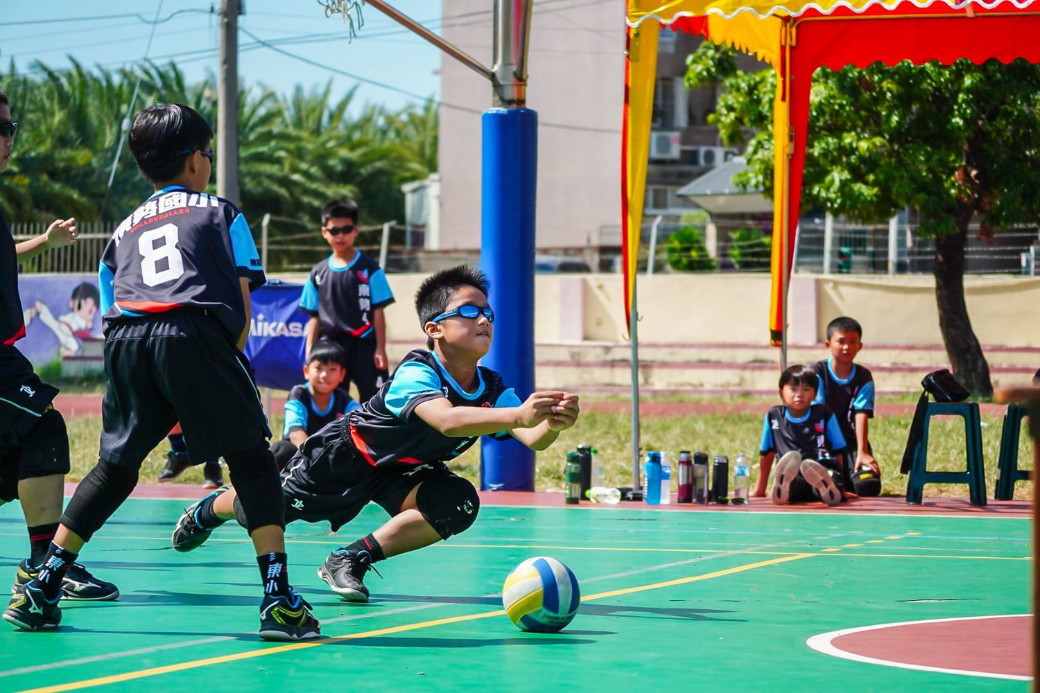 一群小男孩正在球場上踢足球。