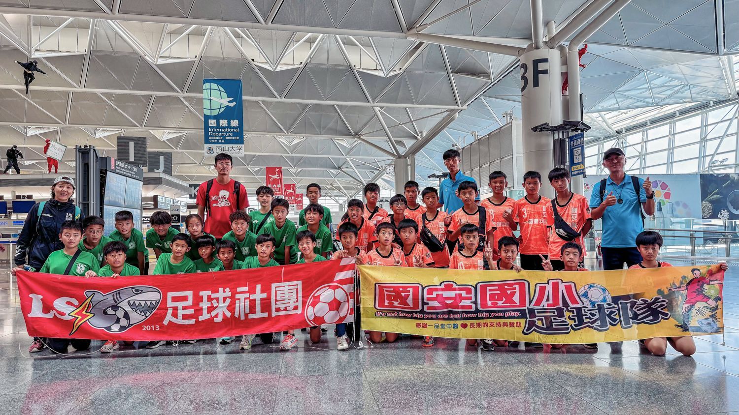 一群孩子在機場擺姿勢拍照。