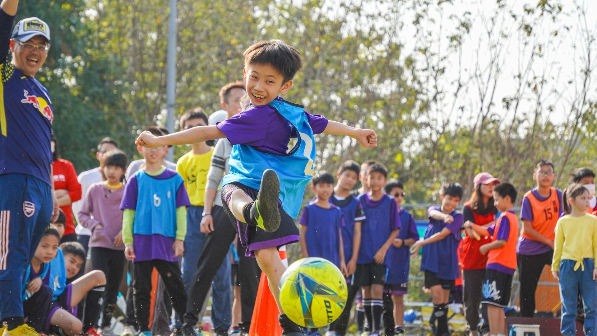 一個小男孩正在空中踢足球。