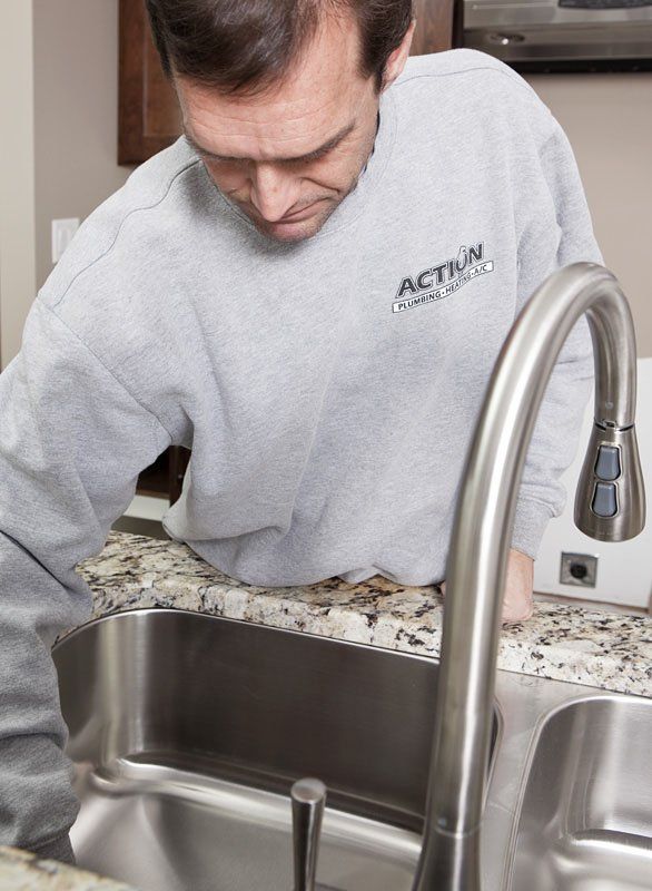 Man Checking the Faucet - Faucet Repair in Rochester, MN Man Checking the Faucet - Faucet Repair in Rochester, MN