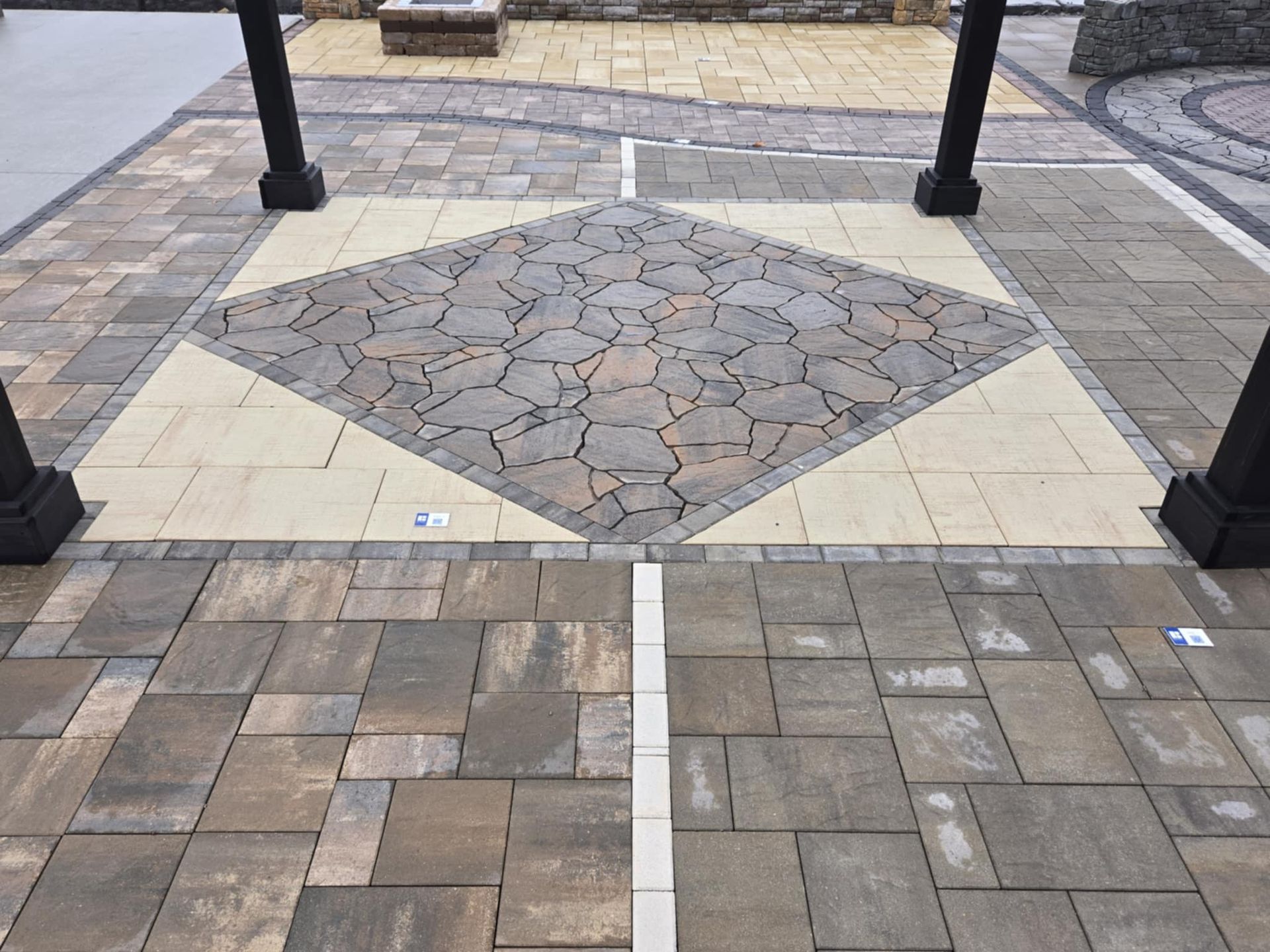 A brick walkway with a diamond pattern in the middle