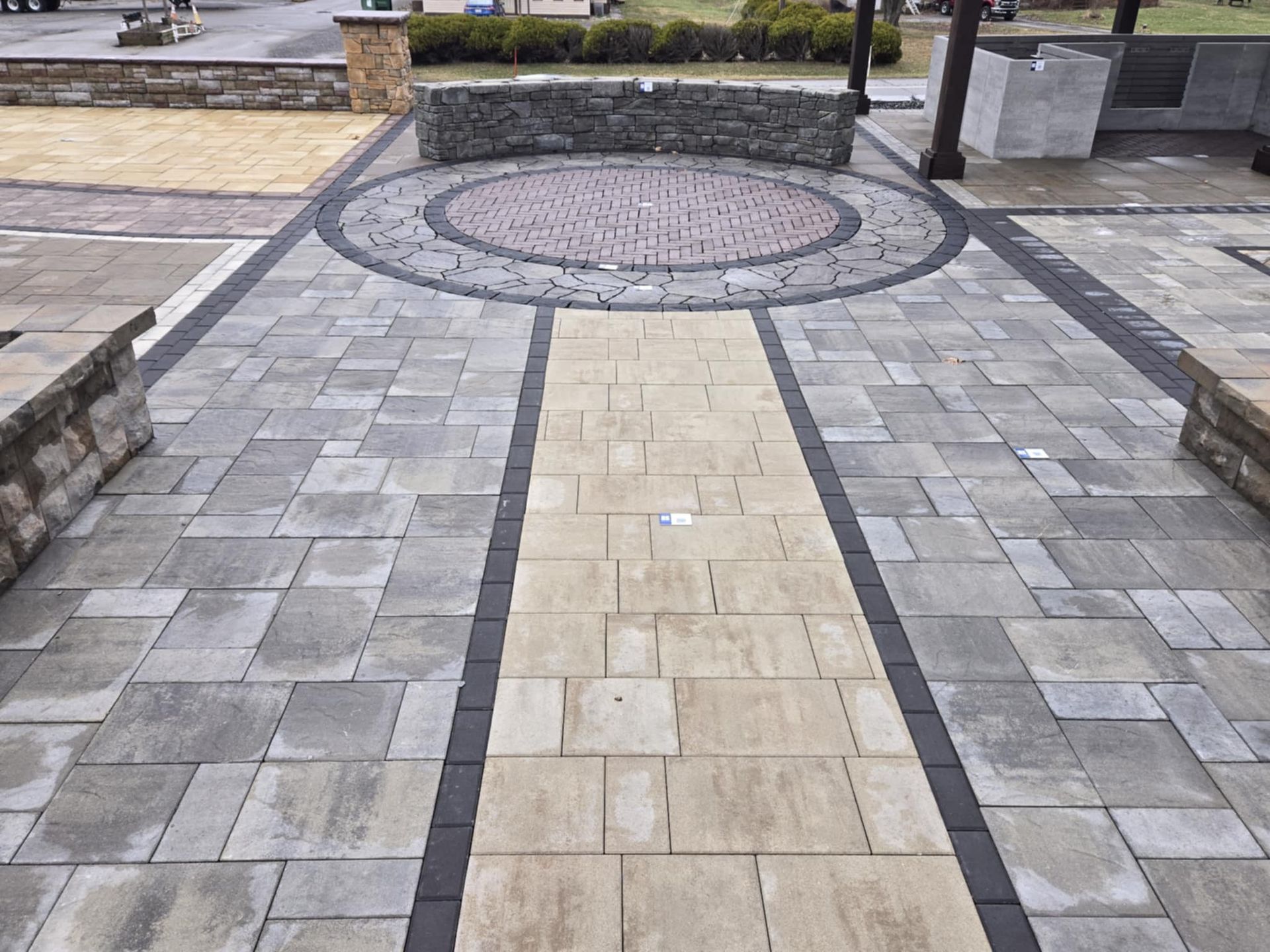 A brick walkway with a circle in the middle