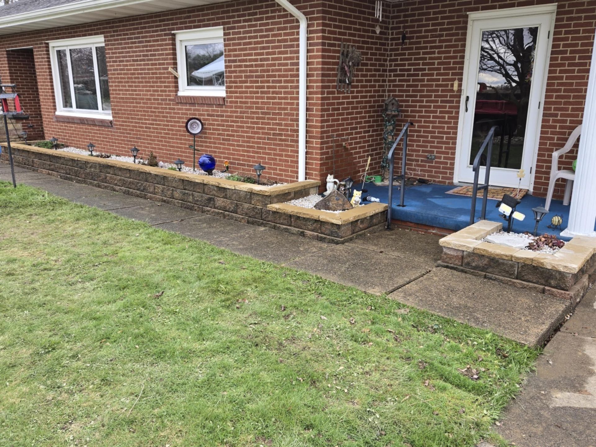 A brick house with a stone walkway leading to the front door.
