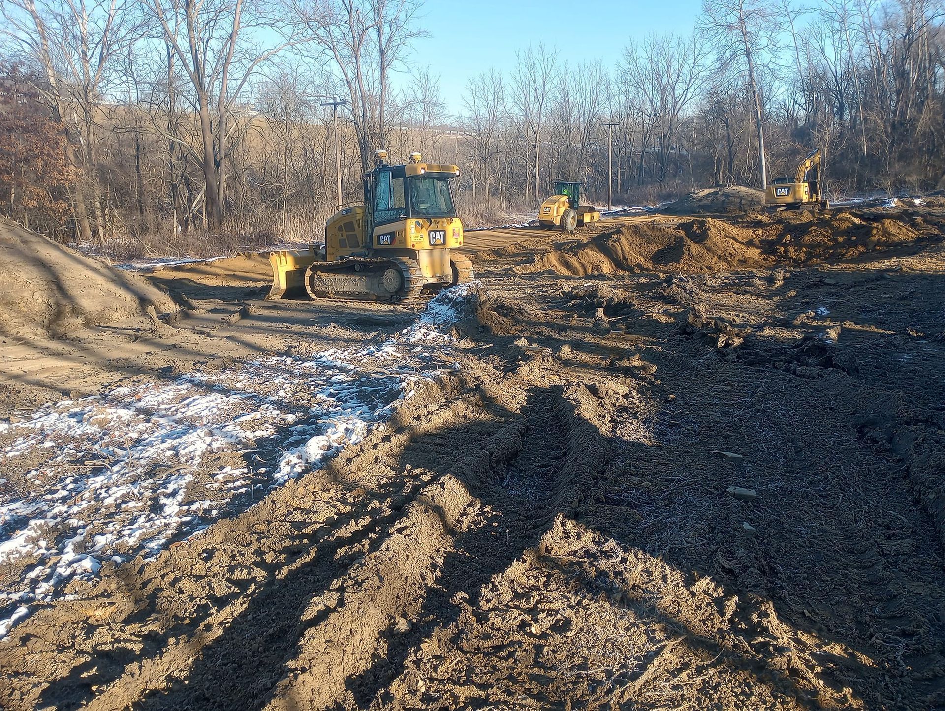 A bulldozer is driving down a dirt road.