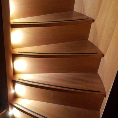 A wooden staircase with lights on the steps