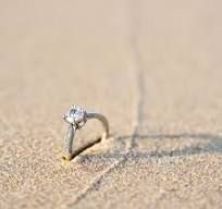 An engagement ring in the sand