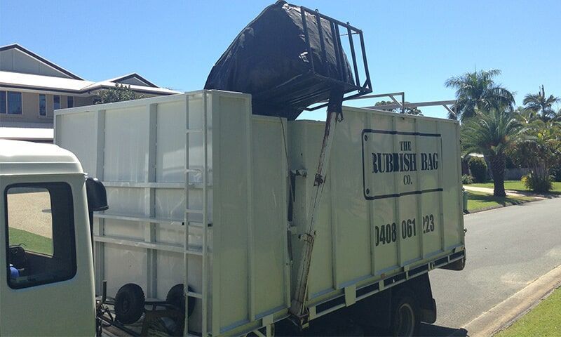 Trash Truck removing Trash from Trash Bag — The Rubbish Bag Co in Sunshine Coast, QLD