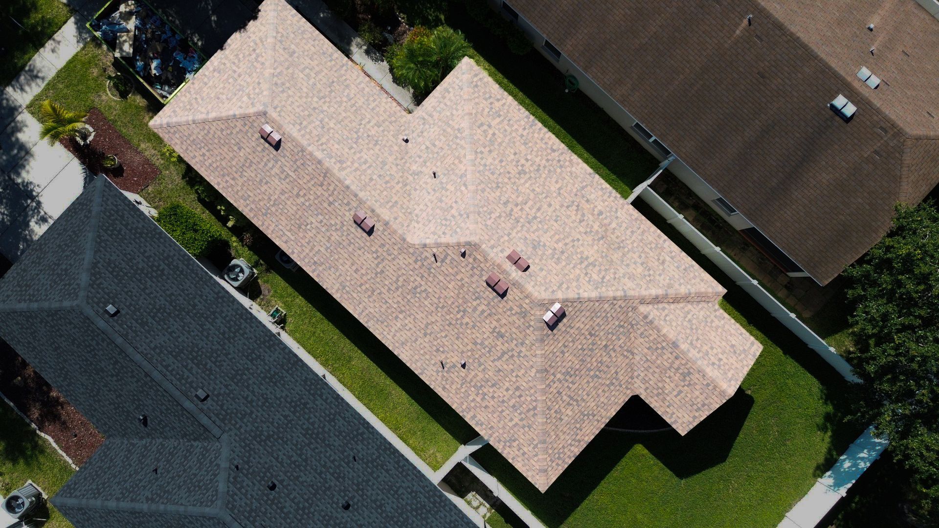 A roof with a window on it and a blue sky in the background